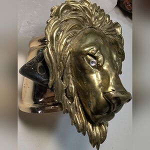 Wendy Gell massive lion head with jeweled eyes and Picasso Stone on a gold cuff.